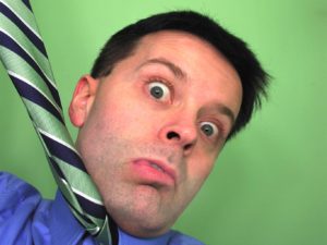 man pulling necktie