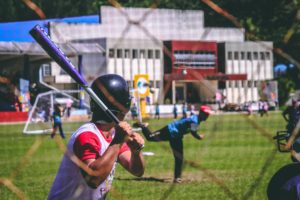 boys swinging the bat in baseball